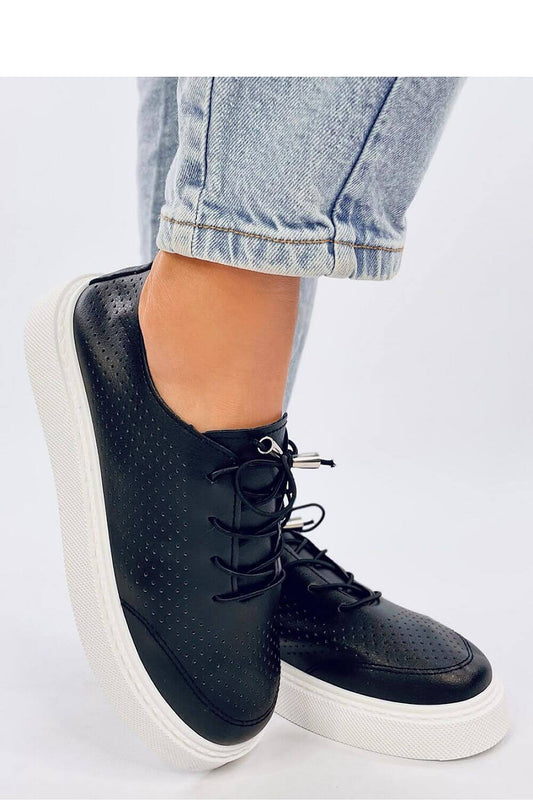 Trendy black perforated sneakers with high soles, perfect for women seeking comfort and style in eco-friendly leather finish.