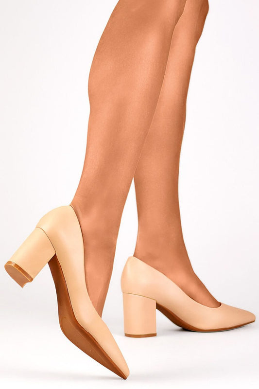 Woman wearing beige eco-friendly leather block heel pumps model 203054 PRIMO, combining elegance and comfort.