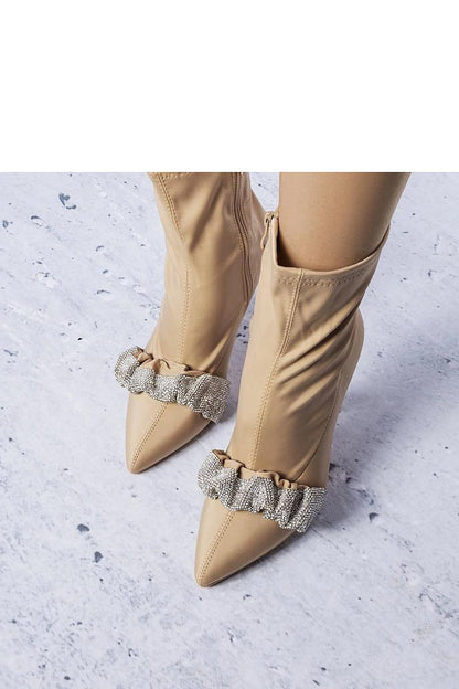 Elegant high-heeled ankle boots with stiletto design and pointed toe, beige with decorative anklet, perfect for evening occasions.