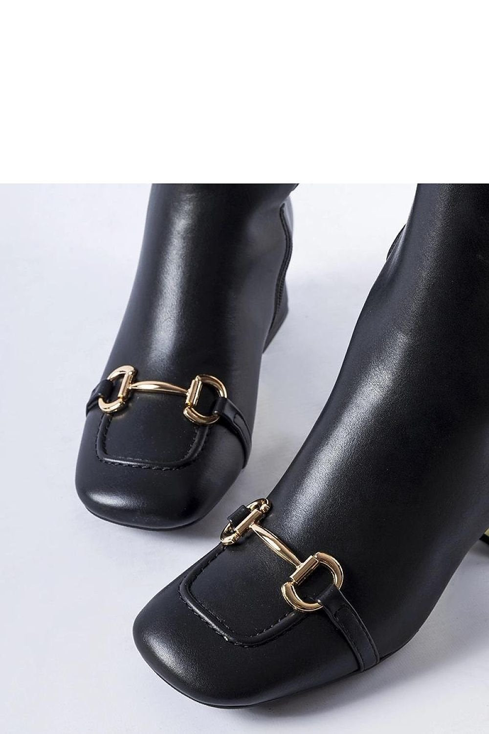 Elegant black ankle boots with gold buckle detail on square toe, featured for autumn and winter fashion.