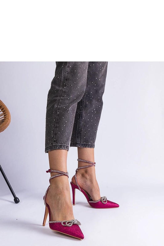 Pink glittery high-heeled shoes with buckle and zirconia detail, perfect for summer days, paired with stylish jeans.