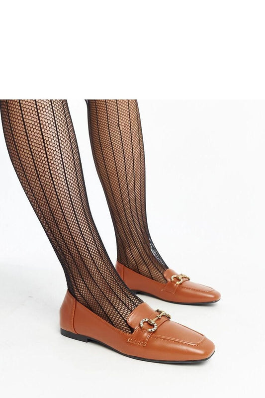 Brown Mokaszin Solea loafers with buckle and zirconia, worn with black fishnet tights, ideal for spring-summer fashion.