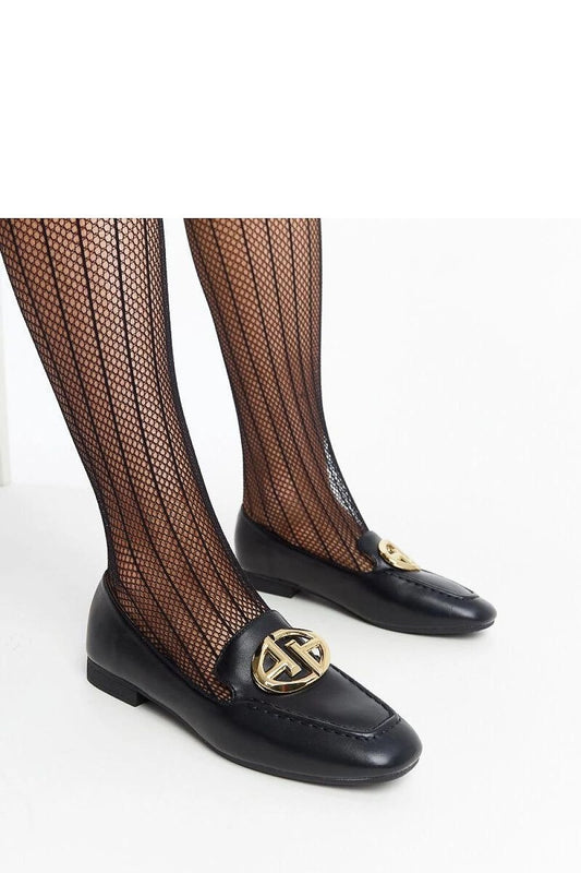 Elegant black leather loafers with gold accents and fishnet stockings, perfect for a chic summer look.