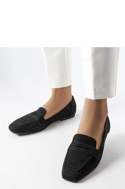 Black Mokaszin Solea on model's feet, elegant synthetic leather loafers perfect for summer, paired with white pants