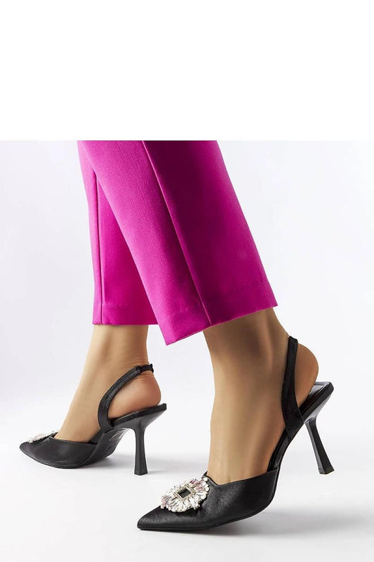 Elegant black high heels with pearls, model 207853 Solea by Dearborn, perfect for summer occasions, worn with vibrant pink pants.