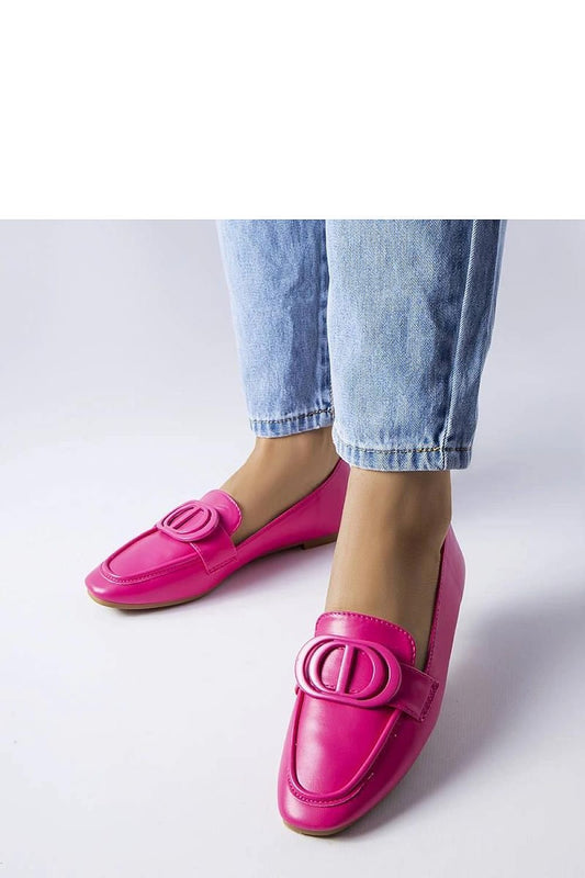 Bright pink Poissonnier loafers with decorative clip and rounded toe, styled with light blue jeans.