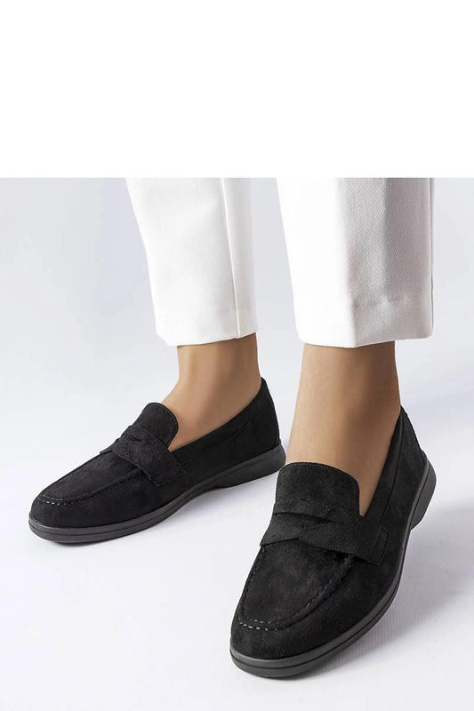 Elegant black Ferragus loafers for women, crafted from high-quality eco-leather, paired with white trousers for a stylish look.