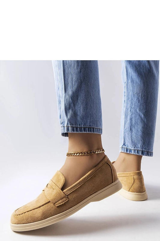 Elegant beige Ferragus moccasins for women paired with jeans, showcasing style and comfort in a minimalist design.