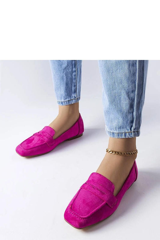 Stylish pink loafers paired with blue jeans perfect for casual elegance.