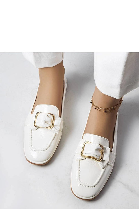 Alt Tag: Elegant white lacquered moccasins with buckle, perfect for women valuing style and comfort, paired with white pants.