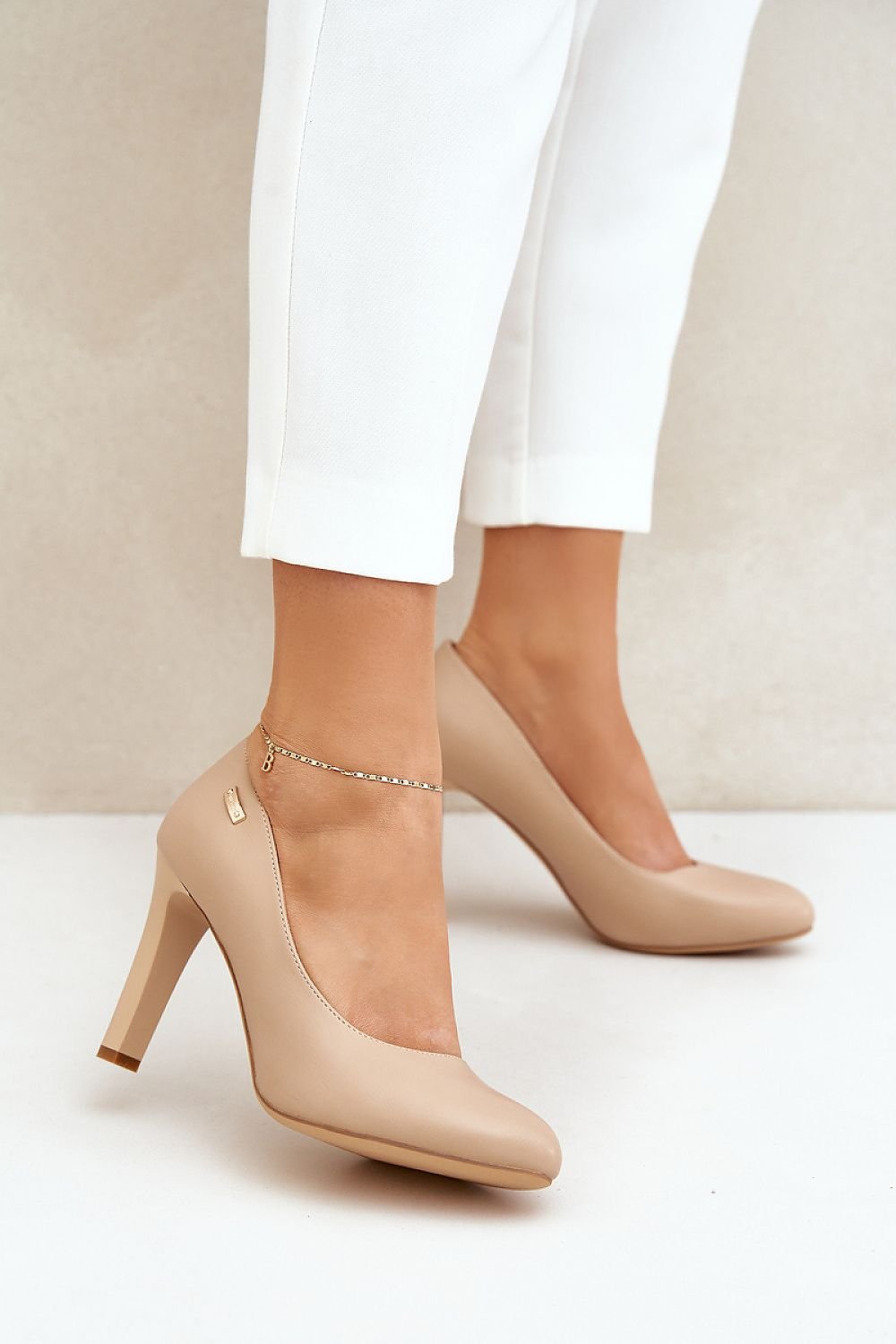 Elegant beige high-heeled shoes with almond toe, perfect for formal occasions, featuring stable heel and soft leather insole.