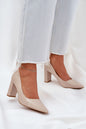 Elegant beige high heels with a pointed toe and block heel, paired with frayed hem jeans.