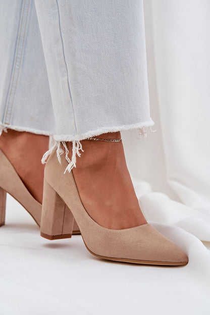 Beige suede high heels paired with frayed hem jeans, perfect for gatherings and business meetings.