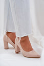 Chic beige suede high heel shoes paired with casual white denim jeans for a stylish look.