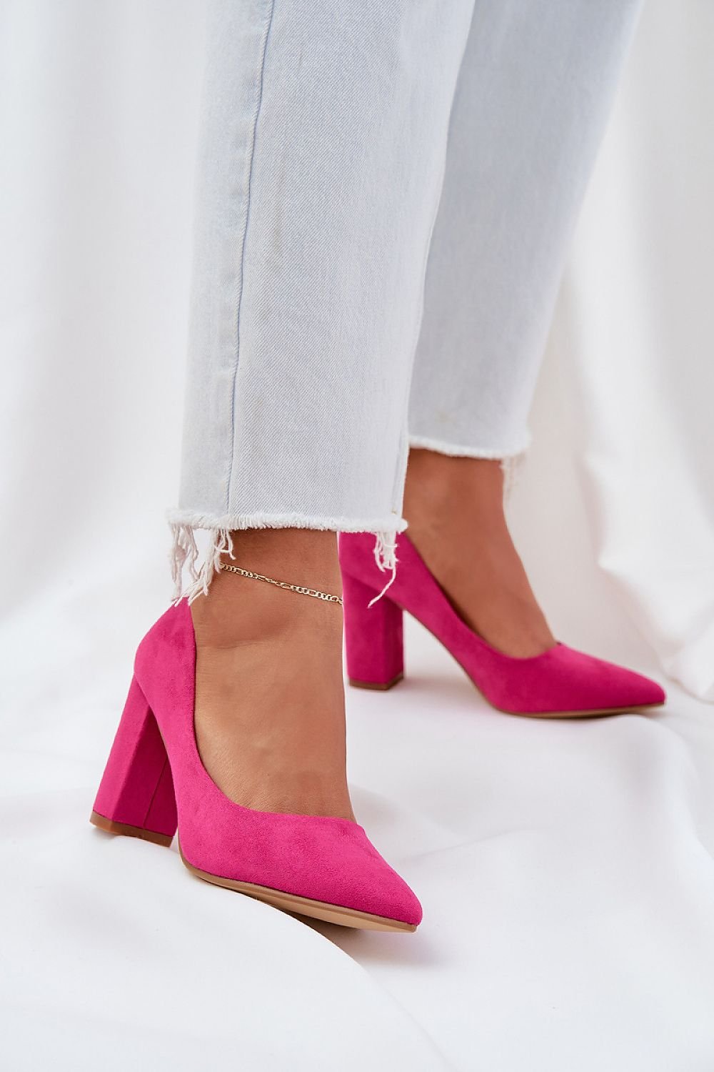 Pink suede high heel shoes with frayed jeans for a stylish look