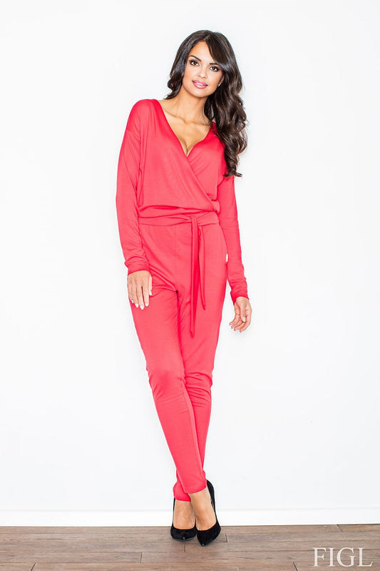 Model wearing figl overál 47953, vibrant red long-sleeve jumpsuit with triangle neckline and flattering waist belt.