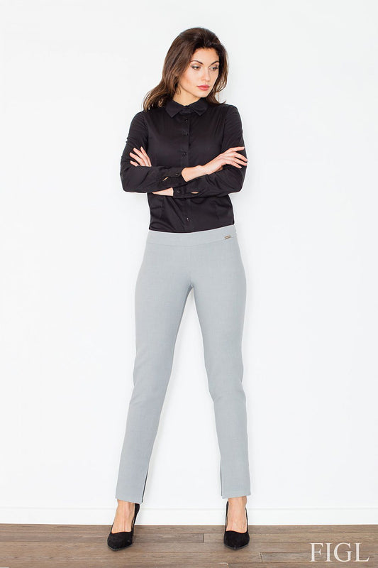 Model wearing női nadrág model 60182 Figl with straight cut and side zipper, gray pants with slits at the bottom.