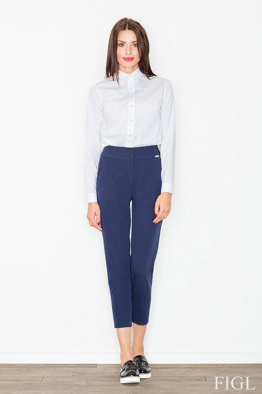 Woman wearing Női magas derekú 7/8 blue pants from Figl, high-waisted with zip and buttons, perfect for versatile occasions.