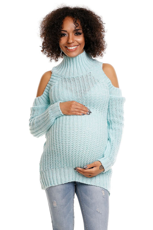 Model wearing a stylish teal maternity sweater with cut-out shoulders, showcasing cozy and fashionable PeeKaBoo design.