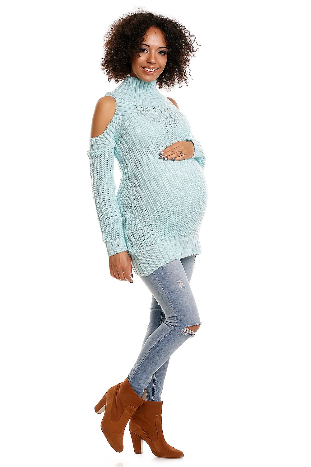 Pregnant woman modeling a long Peekaboo maternity sweater with cut-out shoulders, soft yarn, and stylish design for comfort and fashion.