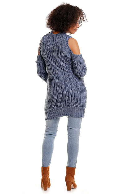 Model wearing blue open-shoulder maternity sweater with long sleeves and ribbed texture, paired with jeans and brown boots.