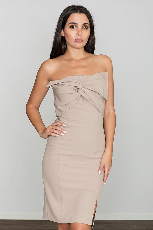 Elegant nude strapless dress with front bow detail and hidden back zipper. Perfect cocktail attire for any occasion.