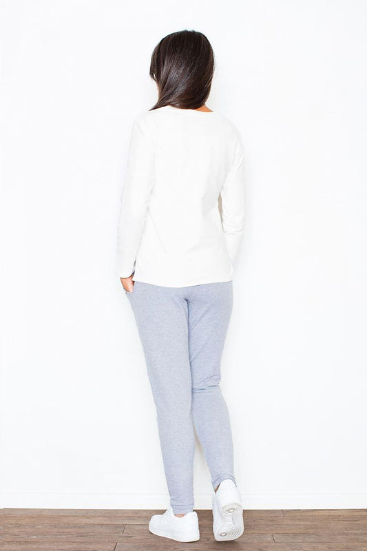 Model wearing Figl 43914 loose-fitting women's sweatpants in soft cotton, back view, showcasing cuffed legs and comfortable fit in blue.