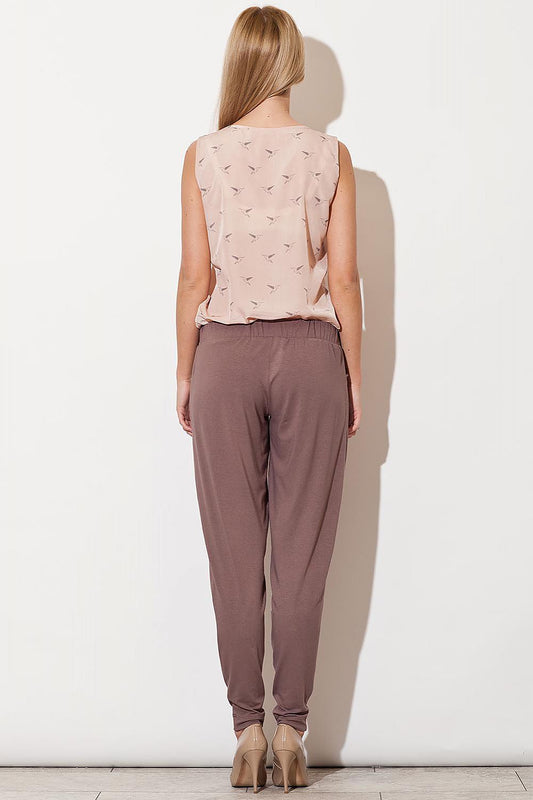 Back view of woman wearing Figl model 29398 pants with drawstring waist and relaxed cut in taupe color.