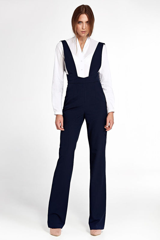 Navy wide-leg jumpsuit with high waist and pockets, inspired by vintage style, full front view. Model wearing a white blouse underneath.