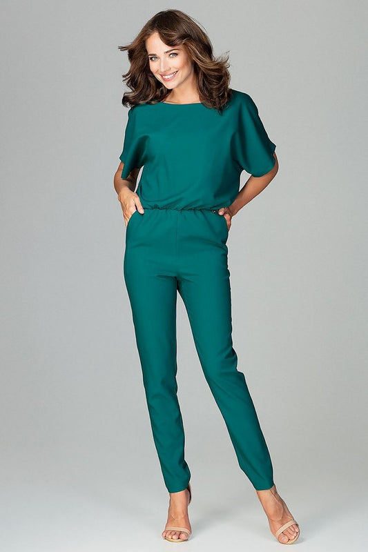 Woman wearing green Lenitif overall with kimono sleeves, ideal for work and casual outings.