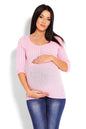 Woman wearing pink maternity sweater PeeKaBoo model 123420 with cable knit top and 3/4 sleeves, paired with blue jeans.