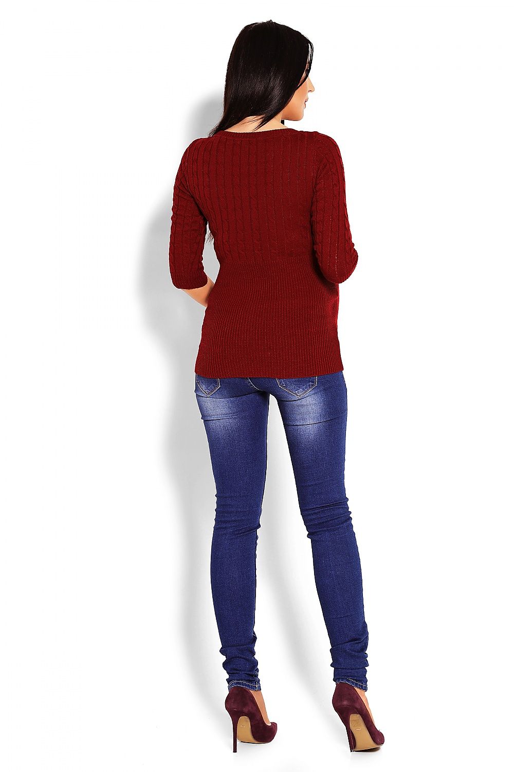 Woman wearing red maternity sweater with braids pattern and 3/4 sleeves, paired with blue jeans and heels, back view.