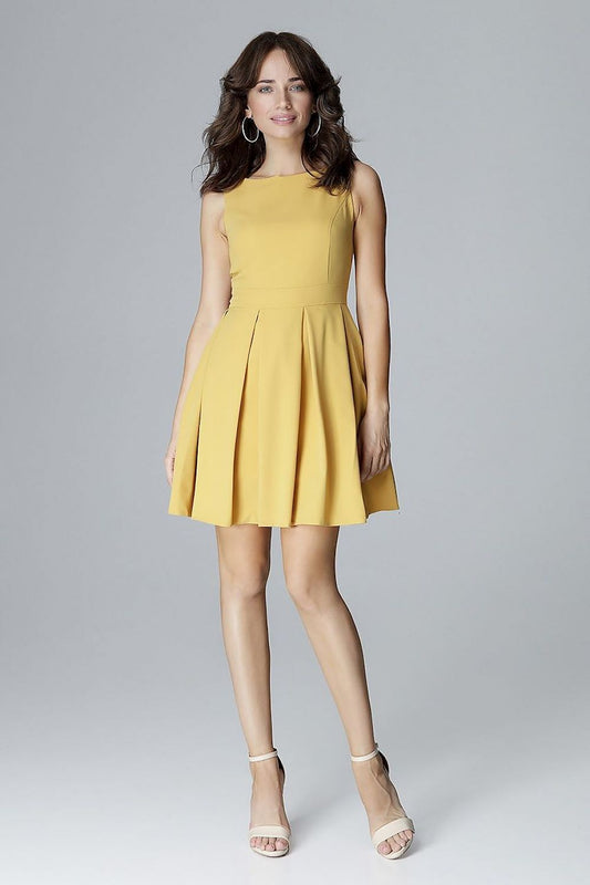 Woman wearing yellow sleeveless dress with fitted bodice and pleated skirt, highlighting waist. Elegant outfit for special occasions.