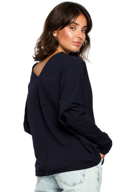 Woman wearing BeWear Szabadidőfelső model 124060, navy pullover with ribbed sleeves and draped neckline, casual chic style.