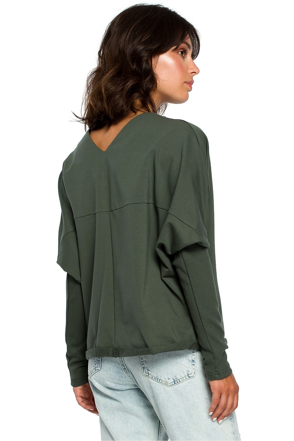 Woman wearing BeWear Szabadidőfelső 124060 in green, showing back draped neckline and ribbed sleeves, casual chic style.