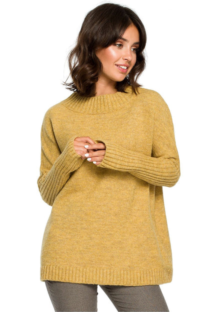 Model wearing mustard yellow knit pullover with long sleeves, styled casually with dark trousers; perfect for elegant or everyday wear.