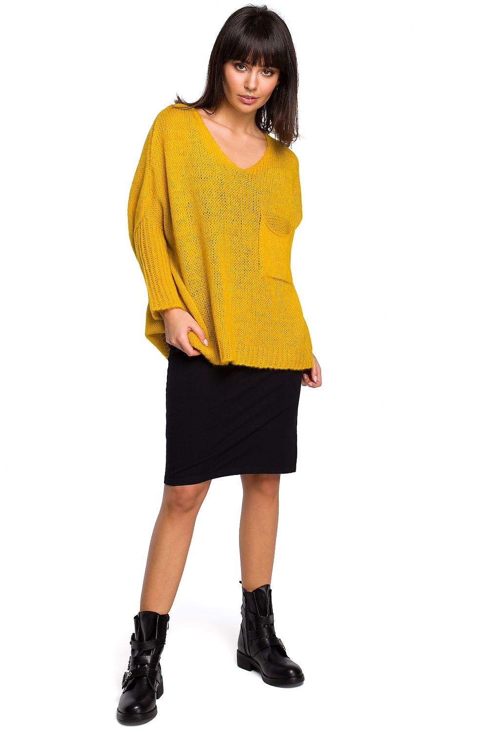 Model wearing yellow Pulóver 129166 BE Knit, loose neckline, ribbed sleeves, paired with black skirt and boots, stylish for all seasons.