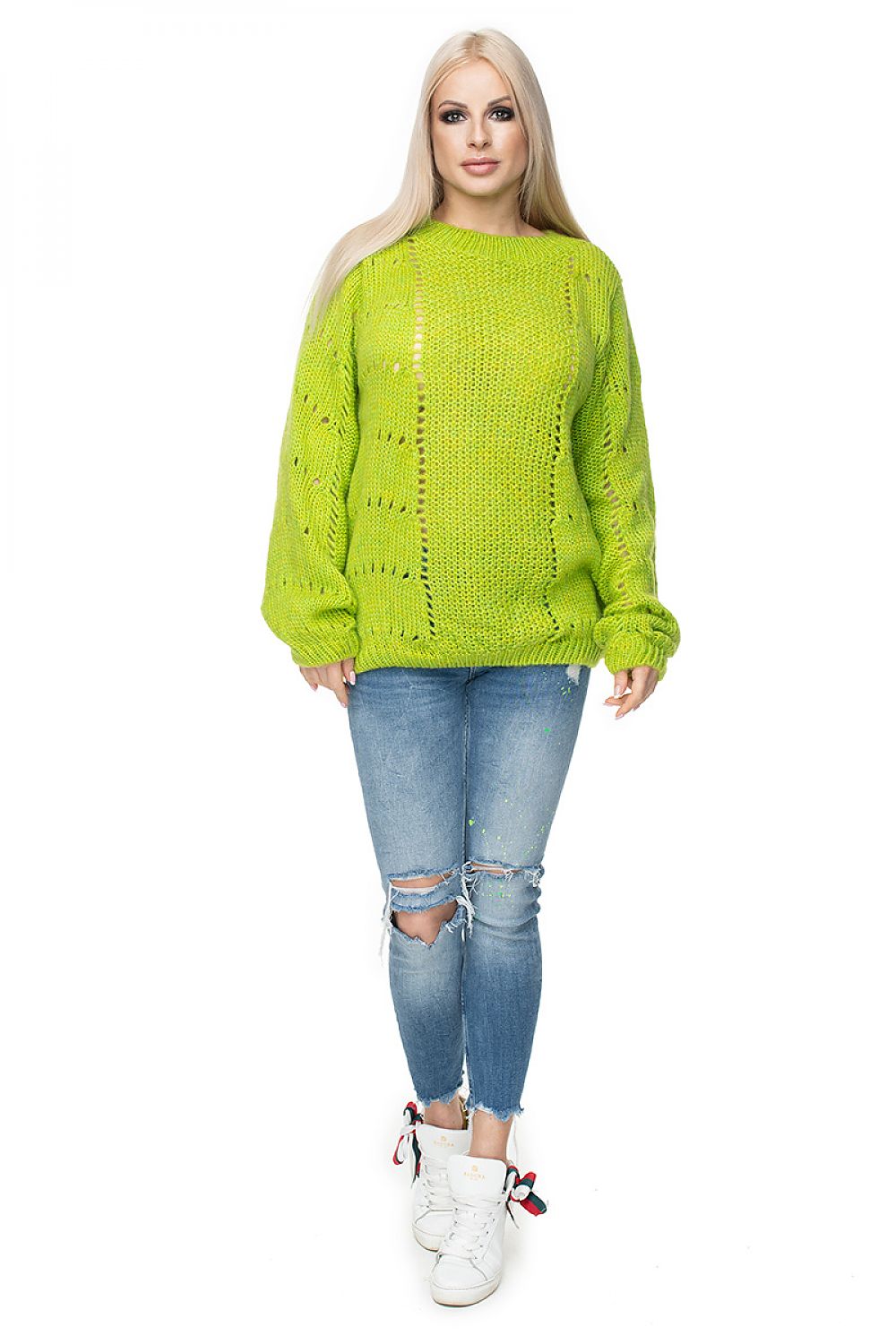 Bright green PeeKaBoo pullover in soft knit with openwork design, shown on model wearing jeans and sneakers.