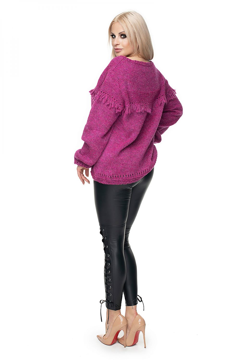 Stylish woman in magenta wool sweater with fringe, model 131603 PeeKaBoo, paired with black leggings and heels, perfect for various occasions.