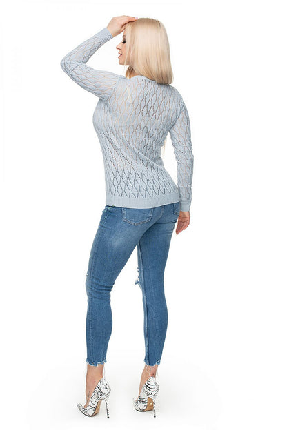 Rear view of a model wearing a diamond-patterned knit sweater and jeans, showcasing a stylish and comfortable PeeKaBoo pullover.