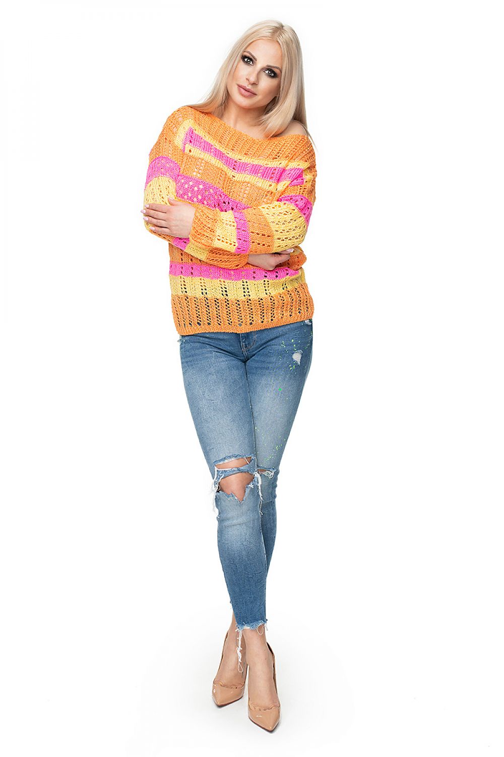 Model wearing colorful PeeKaBoo pullover with openwork pattern and soft yarn, paired with ripped jeans. Fashionable and cozy look.