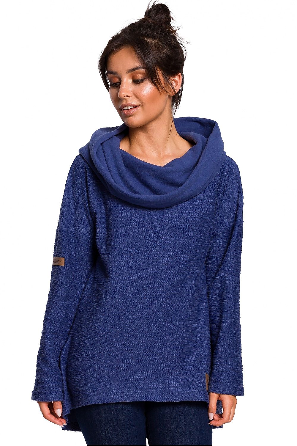 Woman wearing blue asymmetrical BeWear pullover with chimney neckline and hood.