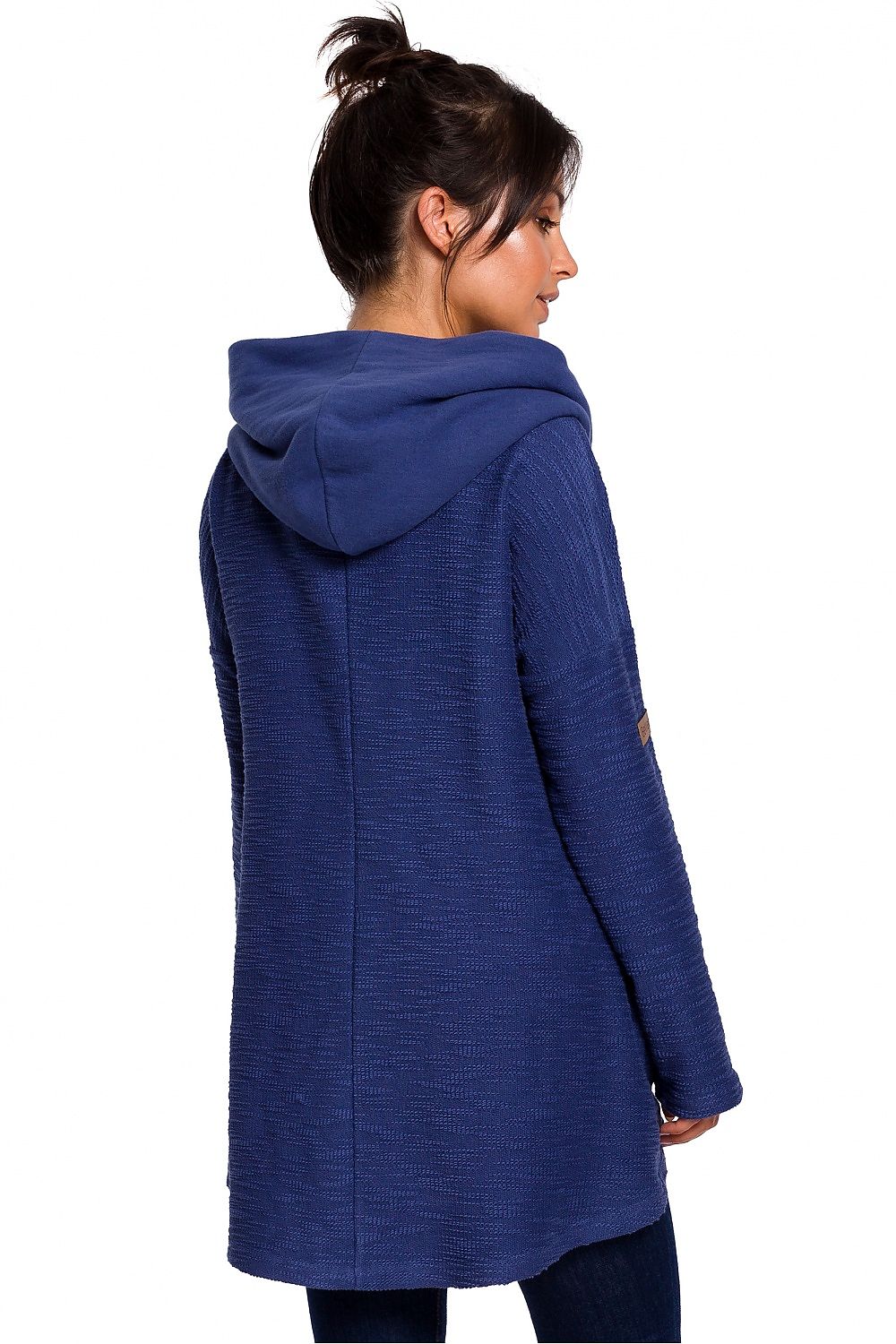 Woman wearing blue asymmetric hooded sweater with pockets, featuring loose chimney collar and cozy fit for colder seasons. BeWear fashion.