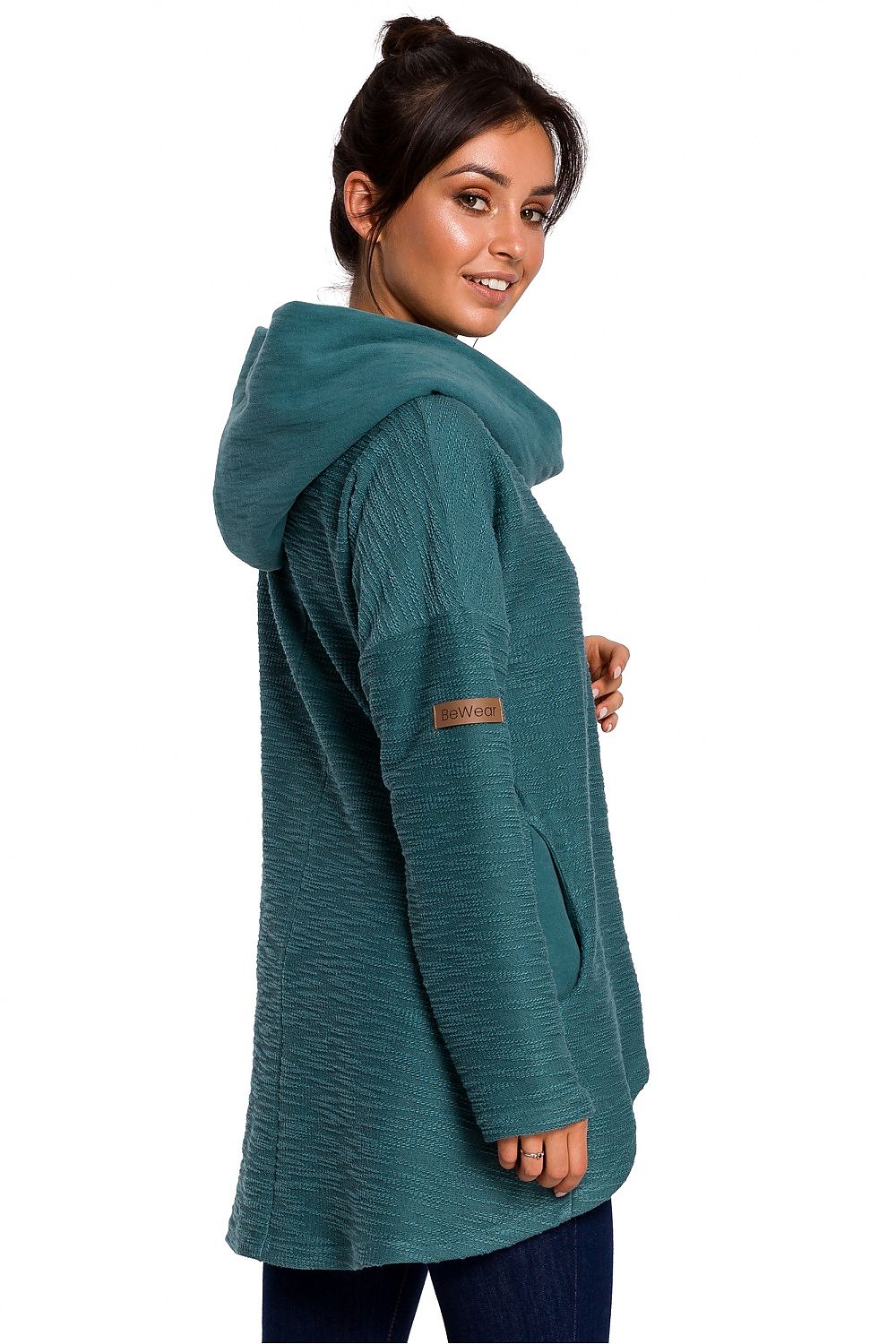 Woman wearing teal BeWear asymmetrical pullover with hood, perfect for cold seasons.