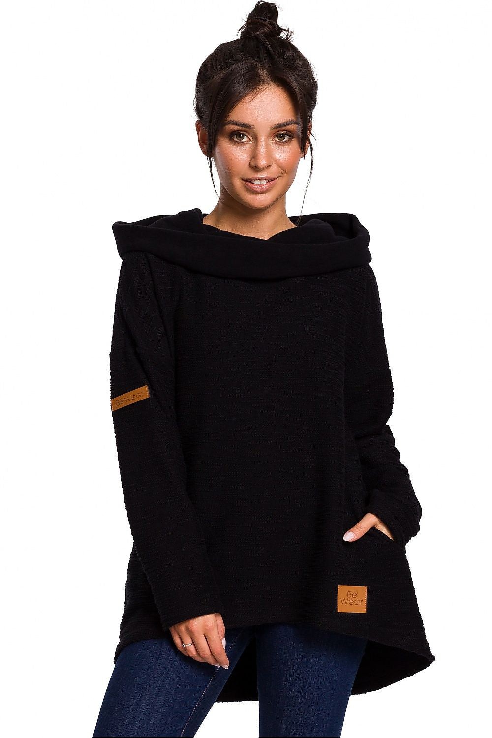 Woman wearing black asymmetrical sweatshirt with hood by BeWear, featuring cozy and stylish design ideal for chilly seasons.