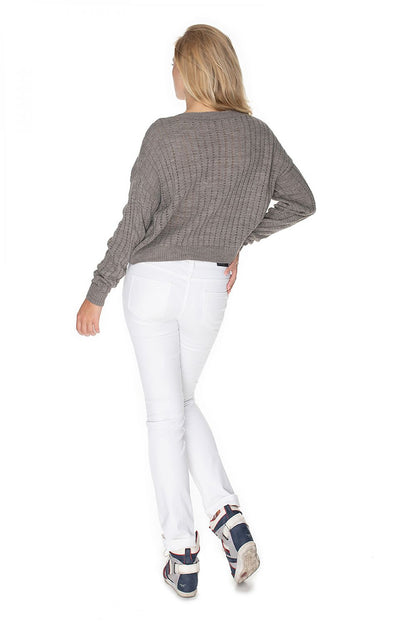 Back view of model wearing grey Pulóver model 134598 PeeKaBoo with long sleeves, unique stitching, and boat neckline.