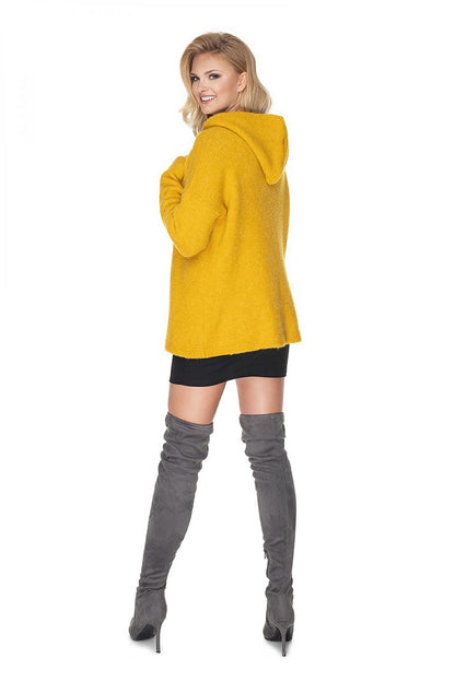 Model wearing yellow hoodie, showing back view, paired with gray over-the-knee boots and black mini skirt, showcasing the outfit style.