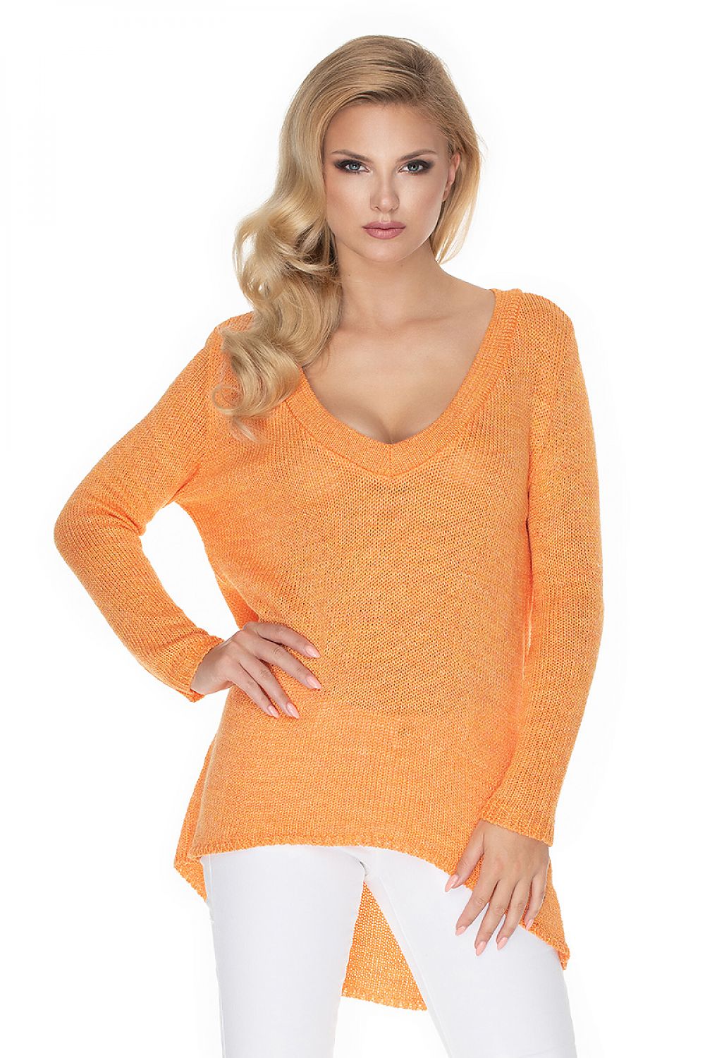 Woman wearing orange asymmetrical oversized pullover with long sleeves by PeeKaBoo. Stylish casual fashion.