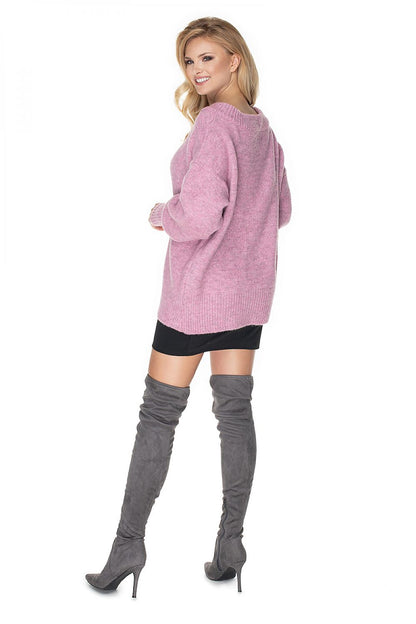 Model wearing pink oversized Pulóver 135317 PeeKaBoo sweater with long sleeves and boat neckline, paired with thigh-high boots.