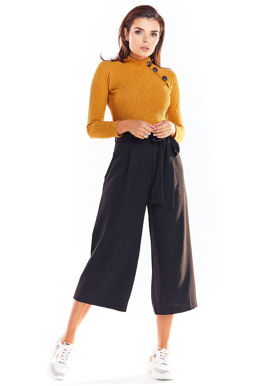 Model wearing fitted mustard pullover with button details, paired with black culottes, ideal for office style.